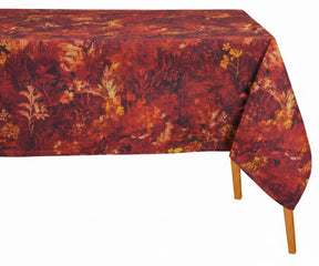 Rectangular autumn floral tablecloth in rich rust red and burgundy tones with botanical print, draped over a wooden dining table.