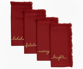 Dark red cotton napkins with gold embroidered words Ho Ho Ho, Fa La La, Merry & Bright – elegant holiday