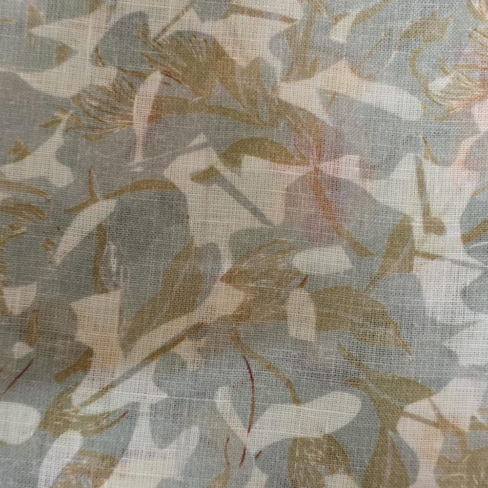 Decorative linen round tablecloth with repeating botanical motif displayed on a round wooden table in a studio environment.