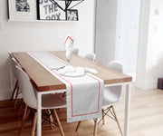 Detailed line embroidery enhances this wedding table runner.