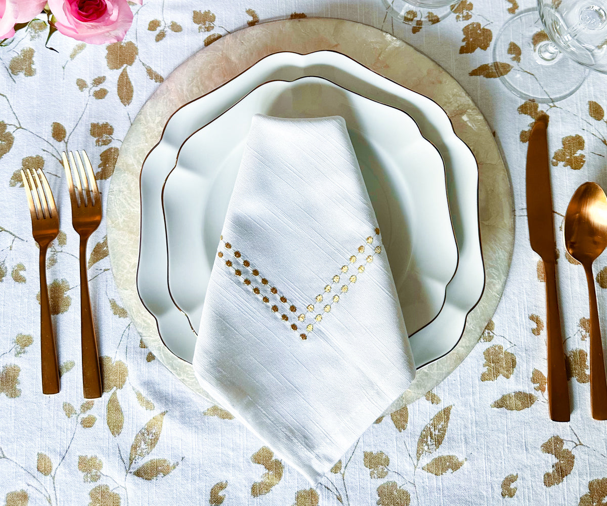 Learn how to fold dinner napkins elegantly, including techniques for folding them with rings. White dinner napkins are a classic choice, and they are commonly used during rehearsal dinners.Gold Dinner Napkins Placed Neatly in a Wooden Holder