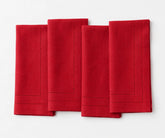 Elegant red linen dinner napkins with double hemstitch trim, designed for Christmas celebrations, holiday entertaining, wedding receptions, and festive dining.