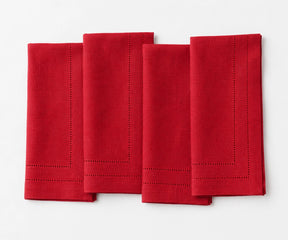 Elegant red linen dinner napkins with double hemstitch trim, designed for Christmas celebrations, holiday entertaining, wedding receptions, and festive dining.