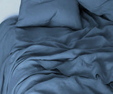 Dusty blue linen bedding set – soft pastel washed European linen sheets for calm, airy bedroom décor.