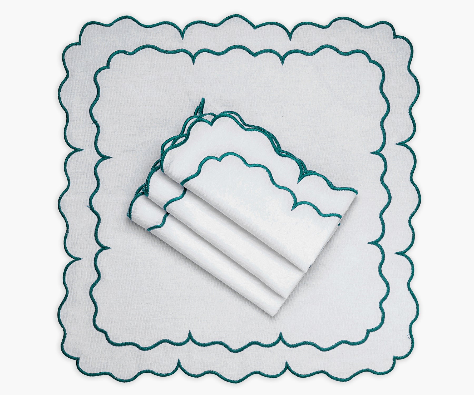 Scalloped napkins in a delightful linen fabric, perfect for special occasions.