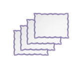 Navy cotton placemats with fine embroidery on a classic wooden table