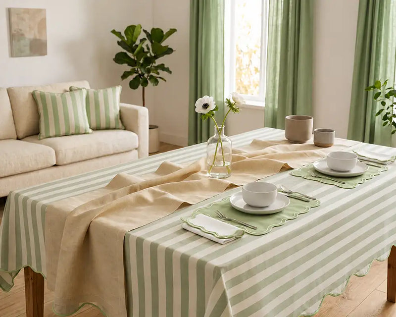 Dining room with a table set for a meal, striped tablecloth, and decor.
