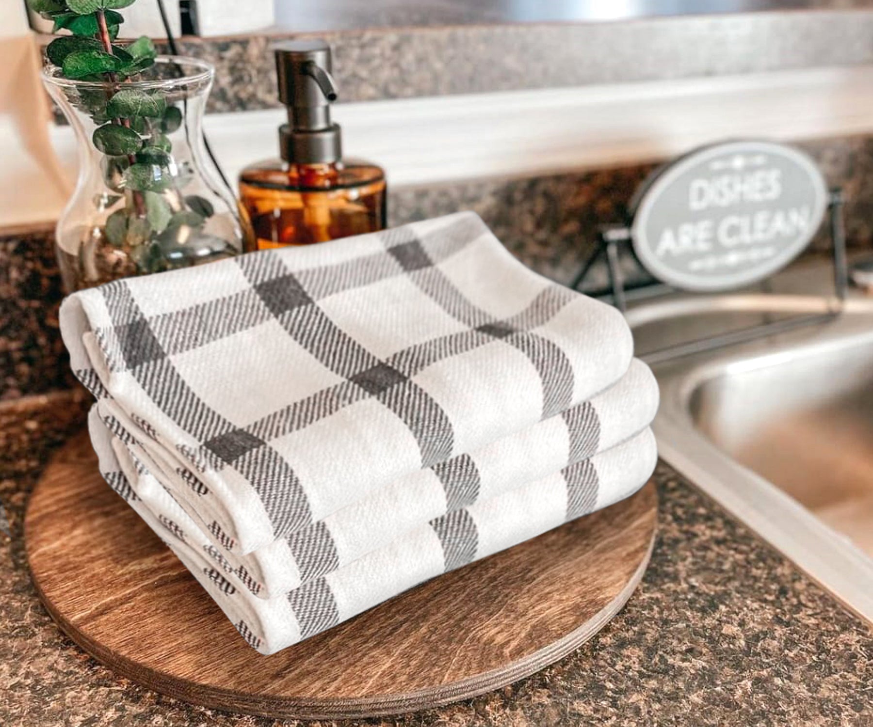 Cotton dish towel resting on a rustic wooden chopping board