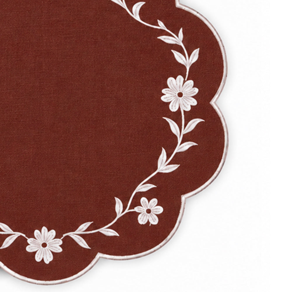 brown scalloped placemat with white floral vine embroidery