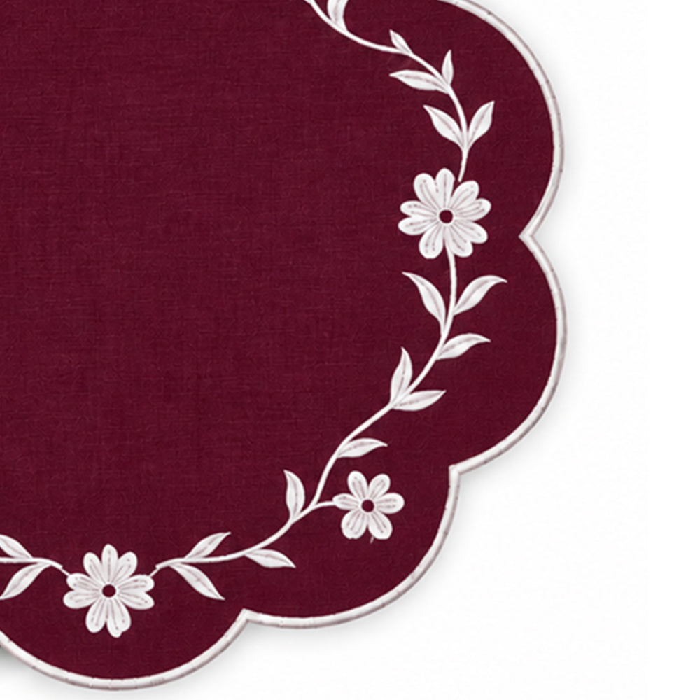 burgundy scalloped placemat with white floral vine embroidery