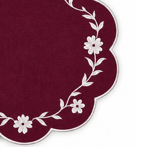 burgundy scalloped placemat with white floral vine embroidery