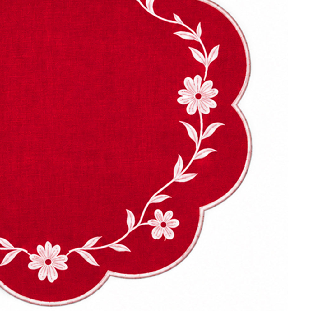 red scalloped placemat with white floral vine embroidery