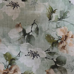 Floral patterned round tablecloth styled over a pedestal table with natural fabric drape and smooth folds.