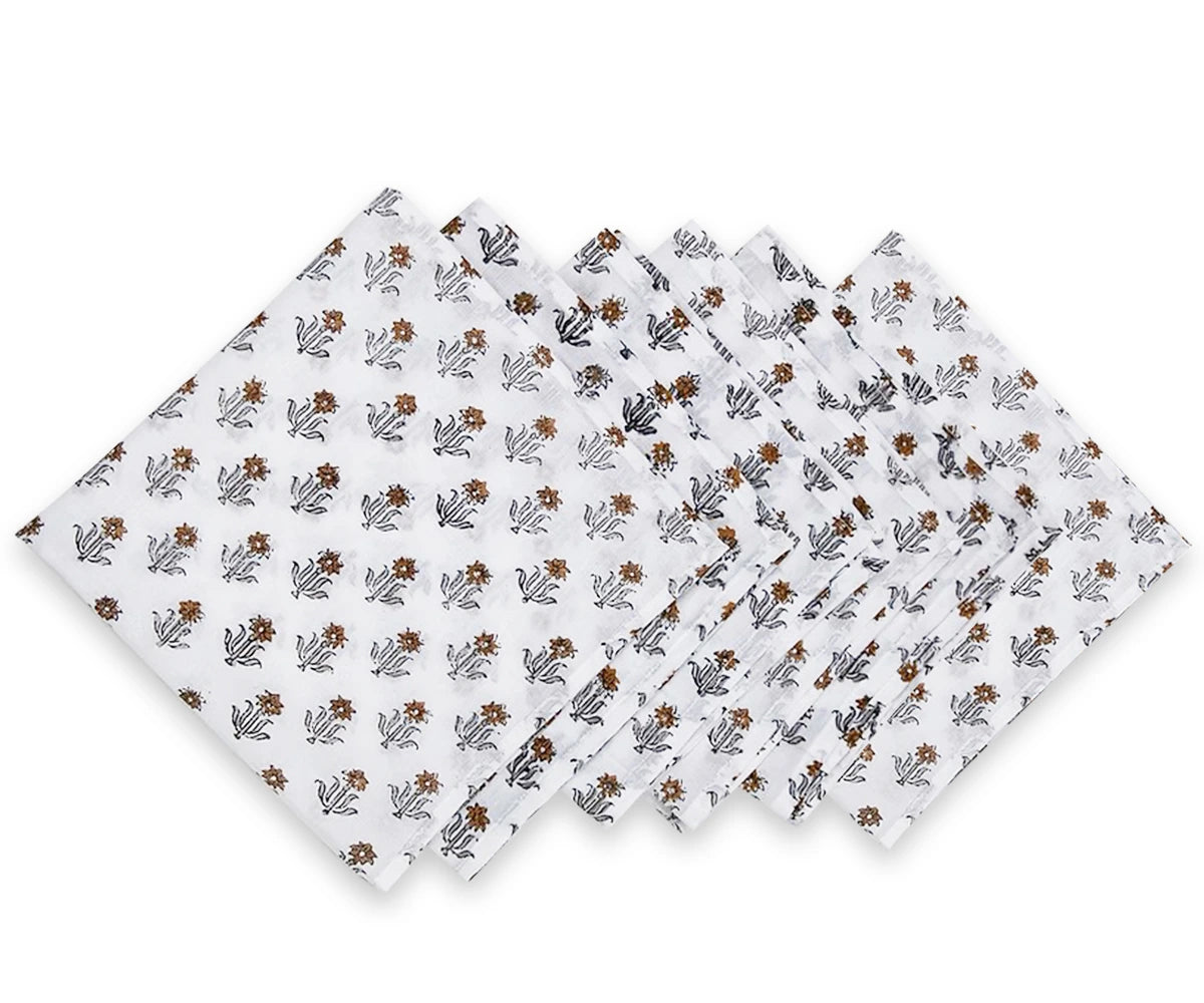 Set of three floral-patterned napkins on a white background