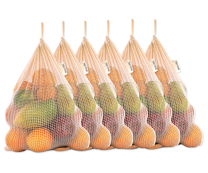 Grocery bags: Mesh BAgs: A collection of six filled reusable mesh produce bags arranged for display.