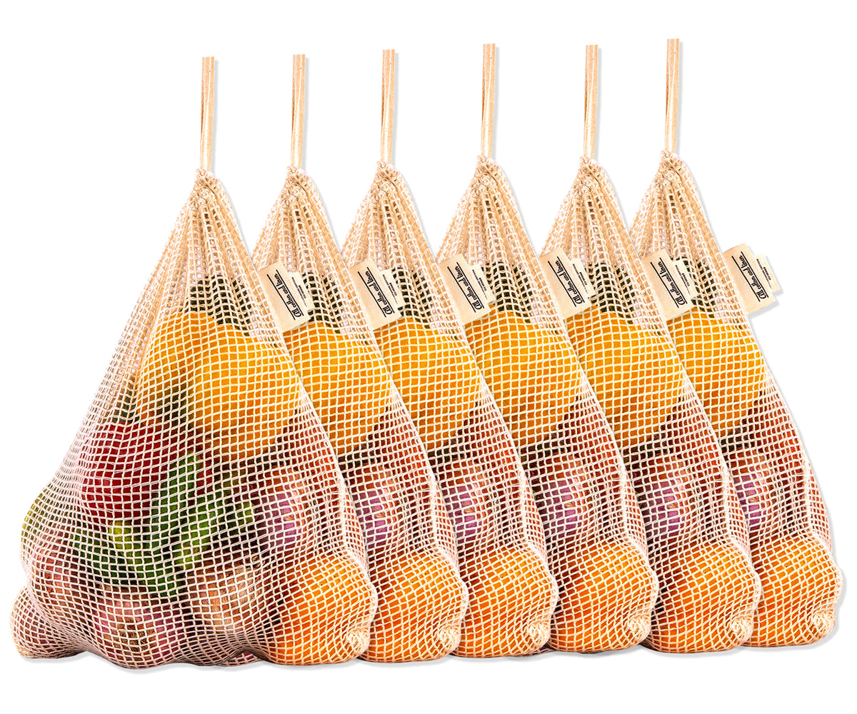 Assorted fruits and vegetables organized in six reusable mesh bags