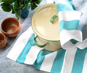 Hanging kitchen towel with hooks for easy and accessible storage.