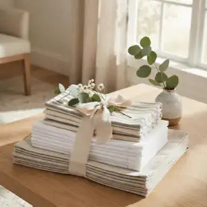 A stack of folded white towels napkin