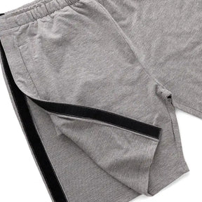 Gray shorts with a black velcro straps on a white background