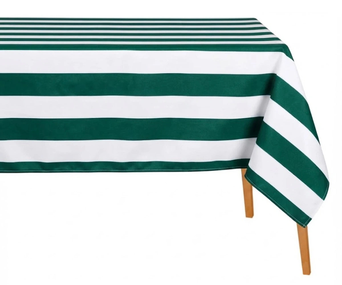 Green and white wide cabana striped cotton linen tablecloth with straight edges draped over a dining table.