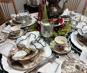 Close-up of soft green cotton napkin with scalloped edges, elegant reusable table décor for home dining.