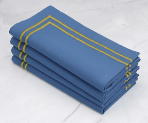 Blue cotton napkins with gold border, folded reusable table napkins