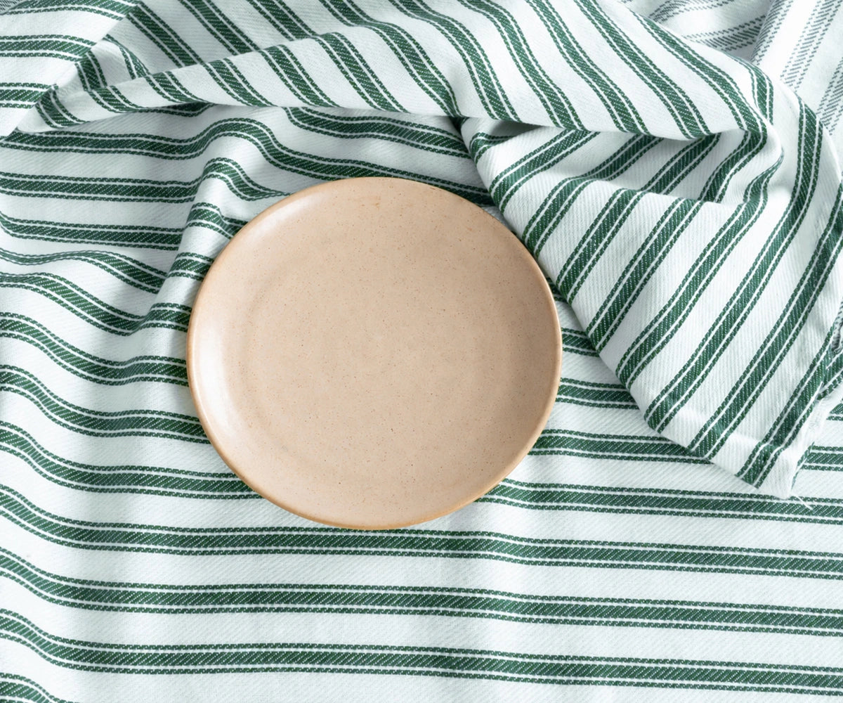Green round tablecloth with classic striped design
