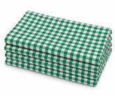 Stack of four neatly folded 100% cotton cloth dinner napkins in a green and white gingham check pattern, displayed on a plain white background.