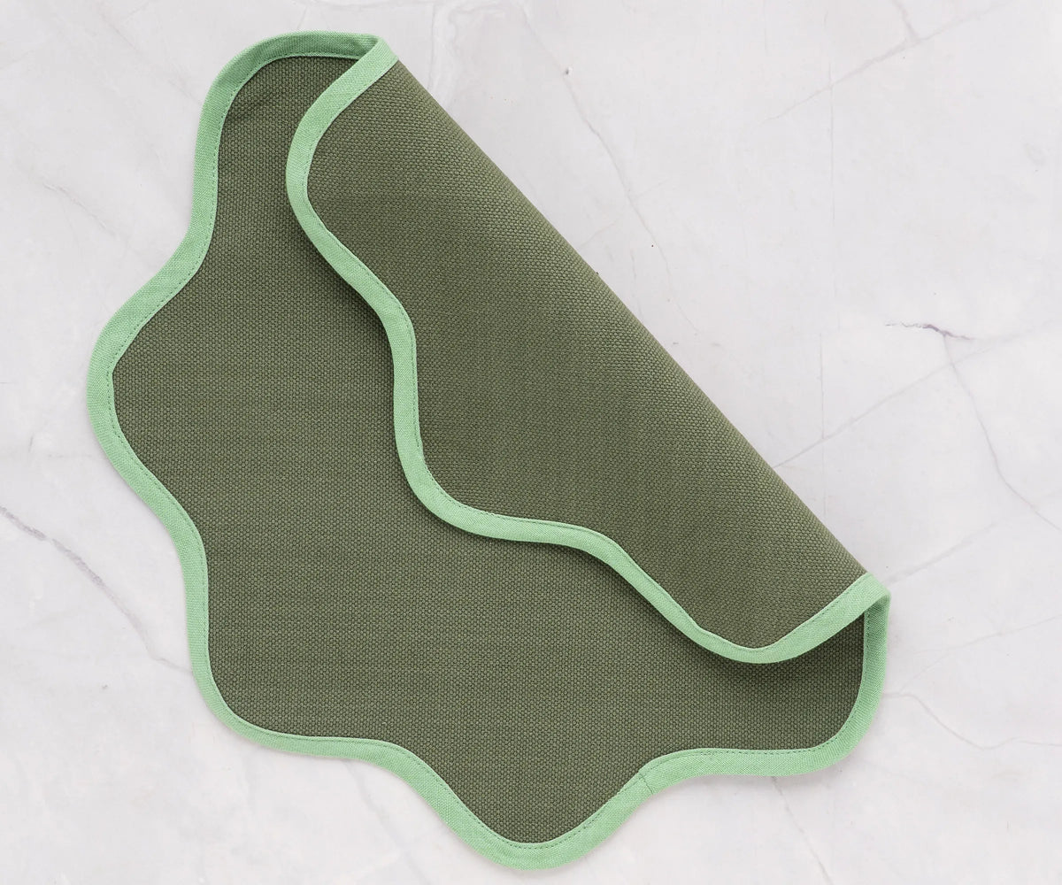 Elegant green cotton placemat with scalloped edge for kitchen or dining table