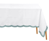 Green cotton tablecloth styled with minimal decor, bringing natural elegance to the dining room