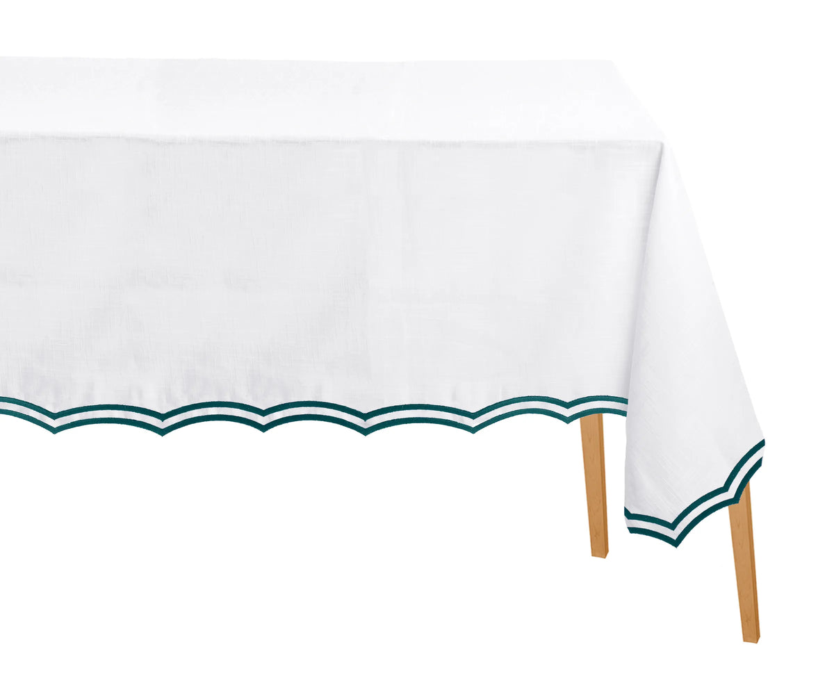 Green rectangle cotton tablecloth with scalloped edges and embroidery on dining table