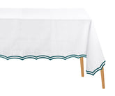 Green rectangle cotton tablecloth with scalloped edges and embroidery on dining table