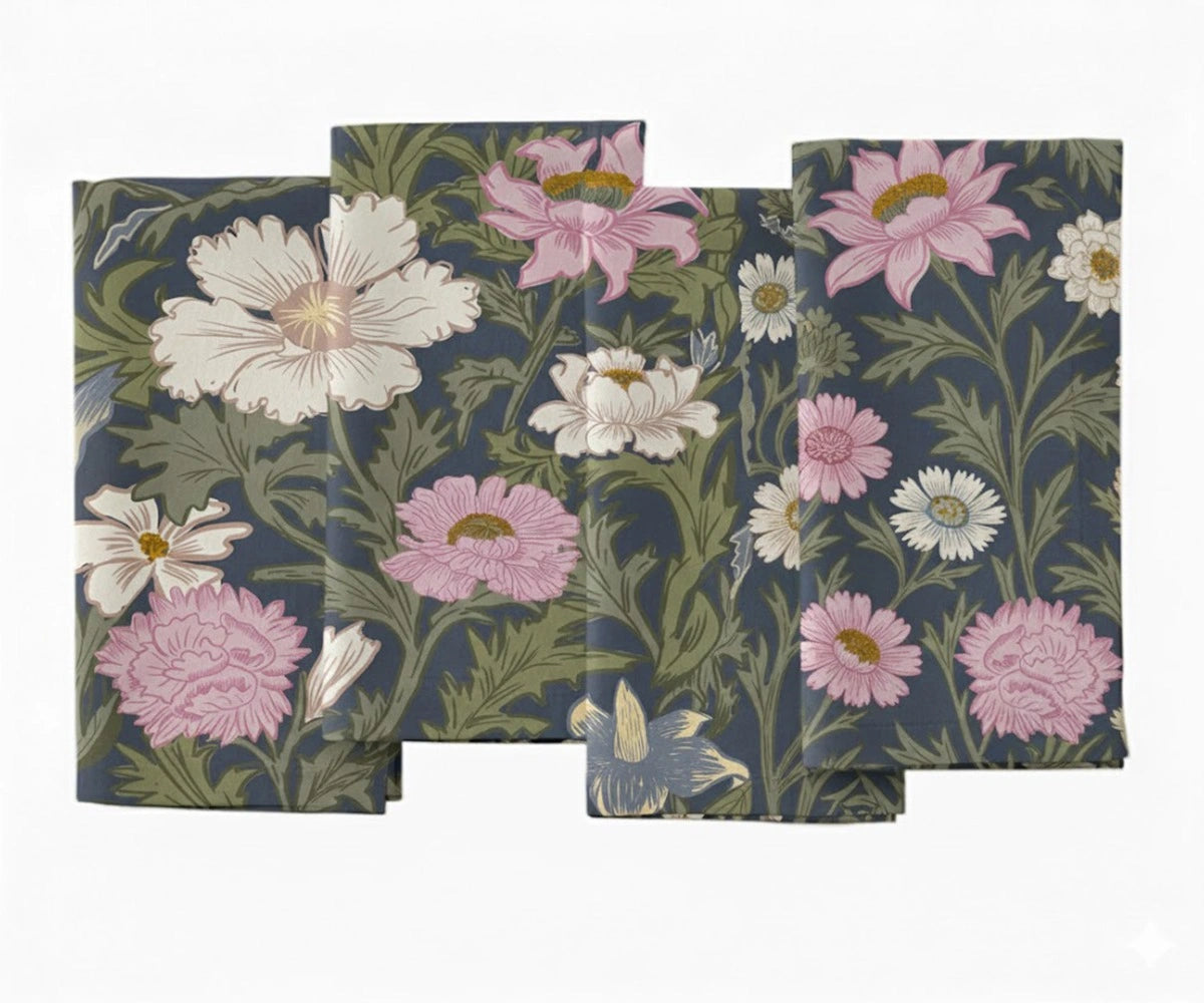 Set of floral printed cotton napkins featuring pink and white flowers with green leaves on a dark blue base.