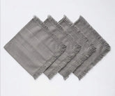 Reusable fringed cotton napkins with soft fabric construction, ideal for dinner tables, gatherings, and everyday dining.