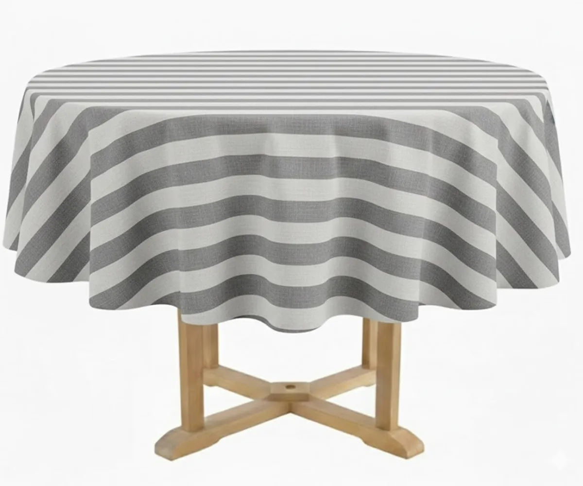 Gray and white striped round tablecloth in 60 inch size crafted from 100% cotton, styled on a round dining table with coordinating dinner napkins and neutral place settings. This cabana stripe round tablecloth suits farmhouse, coastal, and modern décor, ideal for indoor dining, patio entertaining, outdoor gatherings, weddings, and seasonal table styling.