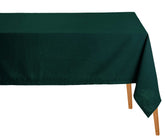 Green tablecloth on a wooden table with a white background