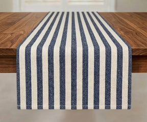 Striped farmhouse table runner in 100% cotton with blue stripes on white base, herringbone weave, styled on wooden dining table