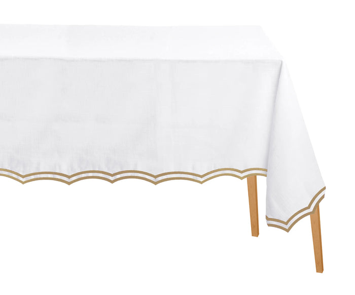 Beige embroidered cotton rectangle tablecloth with scalloped edges on dining table
