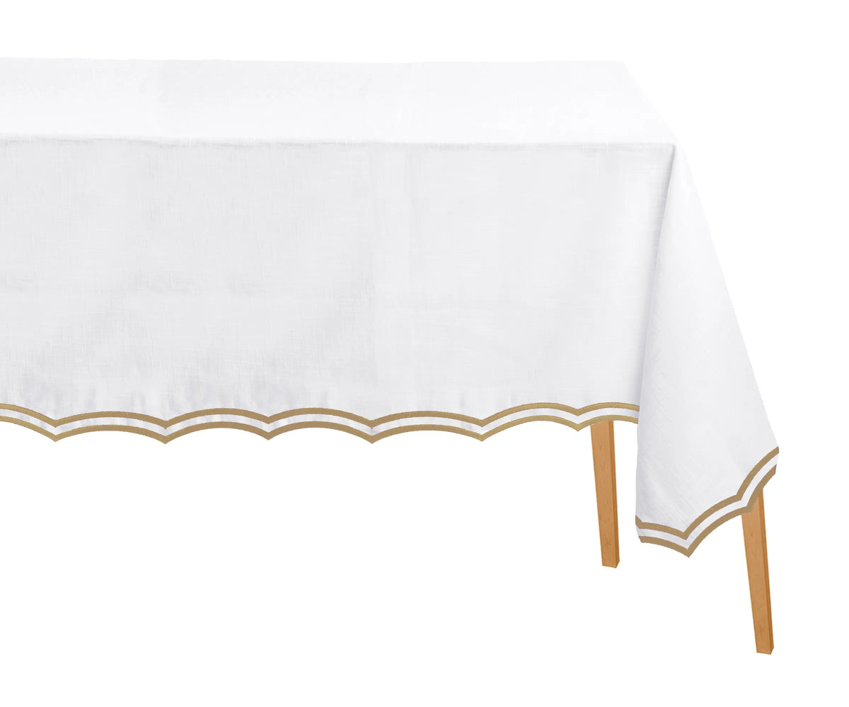 Beige embroidered cotton rectangle tablecloth with scalloped edges on dining table