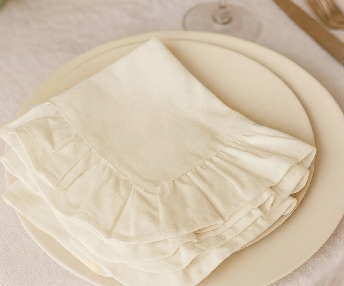 Elegant ivory cloth napkins for weddings, parties, and everyday dining featuring washable premium cotton and ruffle edge design