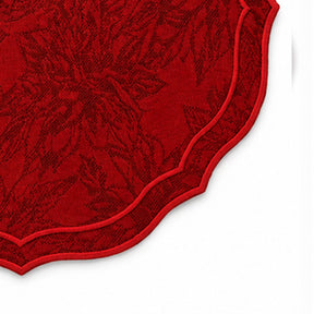 Close-up of white cotton jacquard fabric featuring an elegant woven damask pattern and red scalloped edge detail for premium table linens.