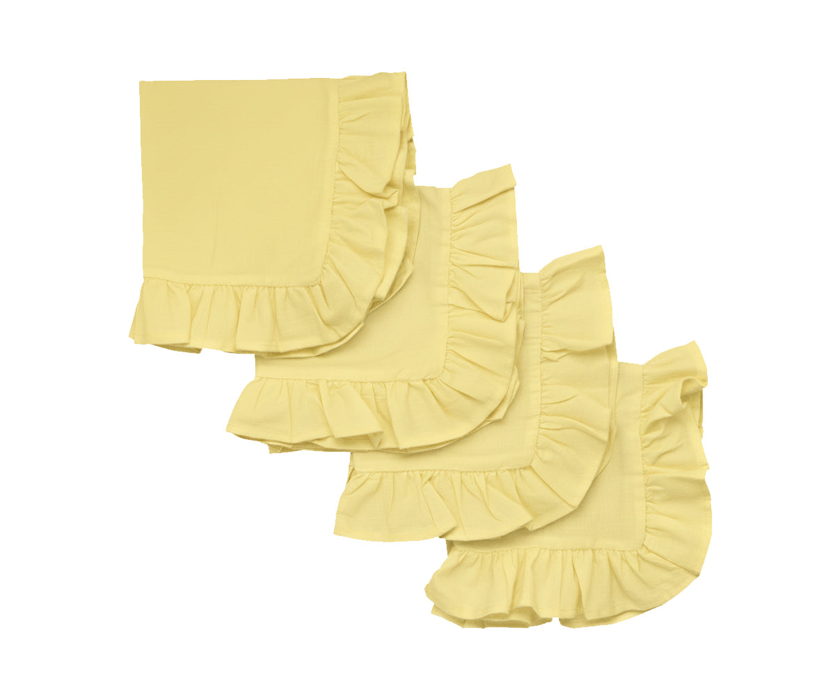 Lemon yellow ruffle edge cotton dinner napkins folded on a dining table
