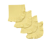 Lemon yellow ruffle edge cotton dinner napkins folded on a dining table