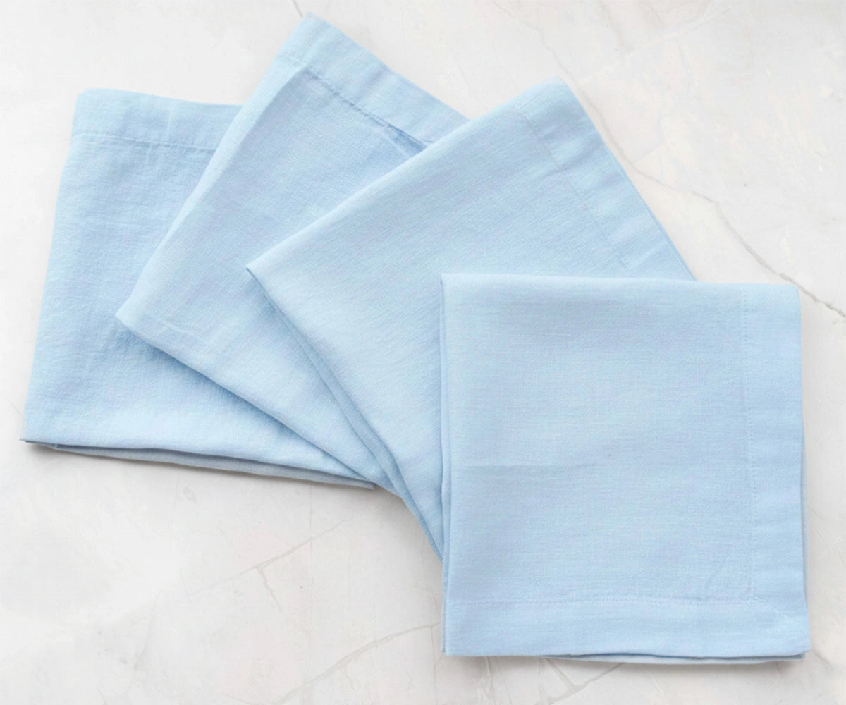 Light blue solid cotton linen napkins styled on table, reusable fabric napkins for casual and modern dining decor