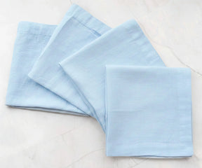 Light blue solid cotton linen napkins styled on table, reusable fabric napkins for casual and modern dining decor