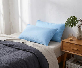 Soft light blue cotton pillowcases on a modern bed with breathable bedding, luxury cotton pillowcases for comfortable bedroom decor
