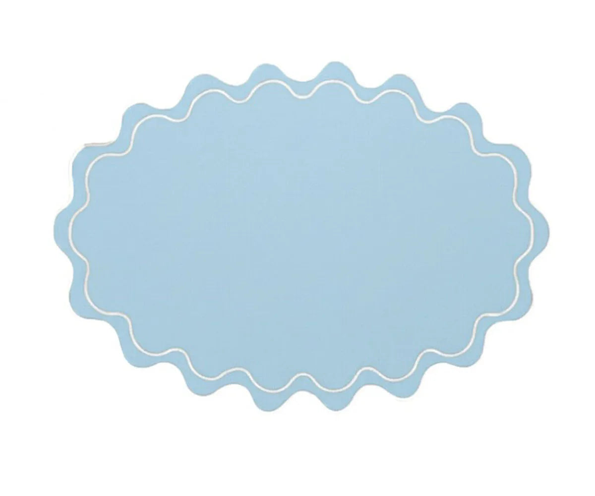 Reusable oval cotton placemat with graceful wavy edges, perfect for elevated table styling and gatherings