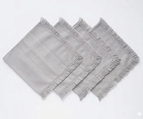 Durable cotton cloth napkins with decorative fringed edges, suitable for restaurants, events, and home dining setups.
