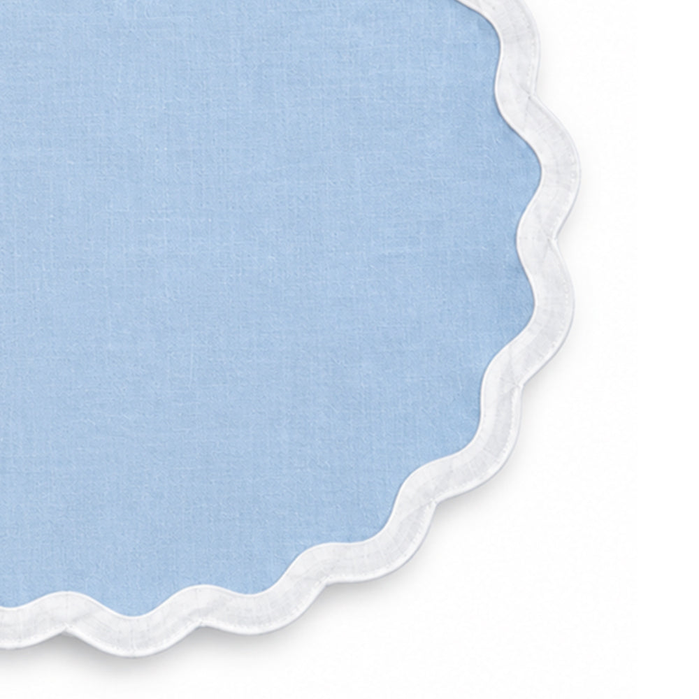 Solid light blue cotton placemat with white scalloped edge trim, decorative fabric table mat for coastal dining decor, summer table settings, brunch, family meals, and everyday dining
