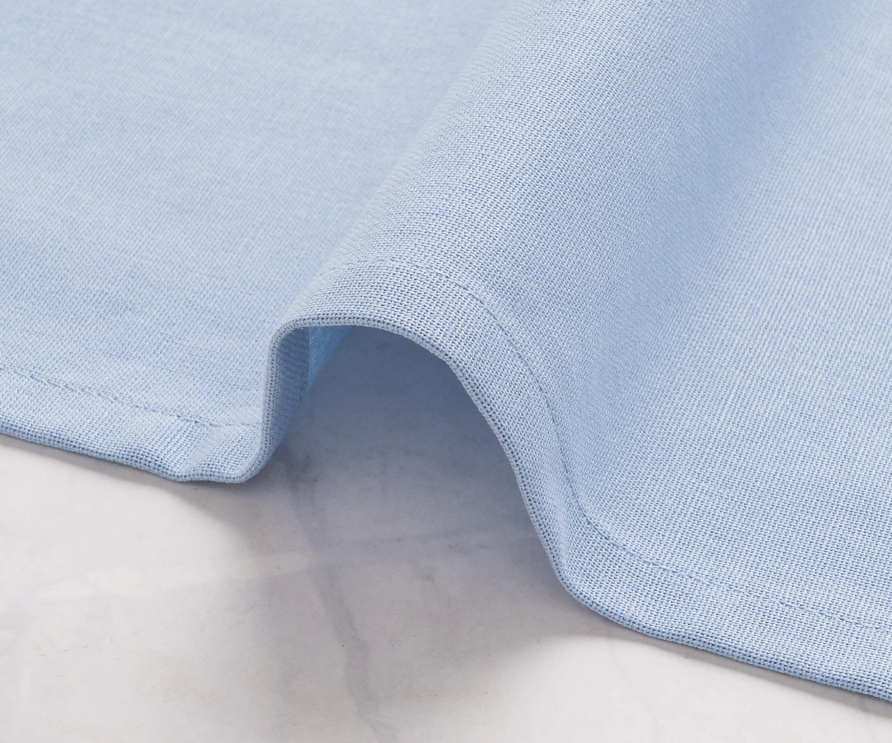 Elegant plain light blue napkins styled for a wedding reception table